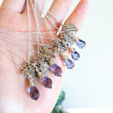 Grape leaf pendant necklace paired with a wire-wrapped faceted glass crystal charm.